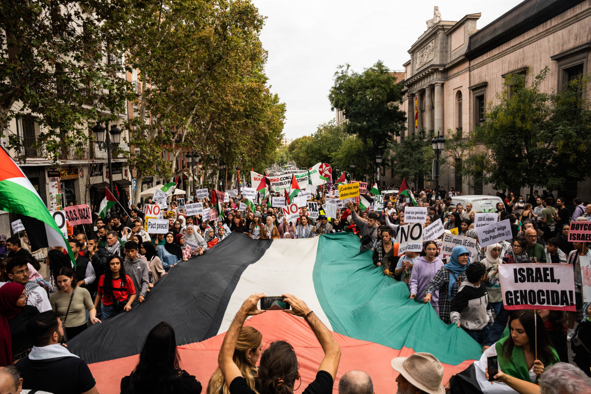 Varias personas con una bandera de Palestina durante una manifestación en apoyo al pueblo palestino, a 15 de octubre de 2023, en Madrid (España).