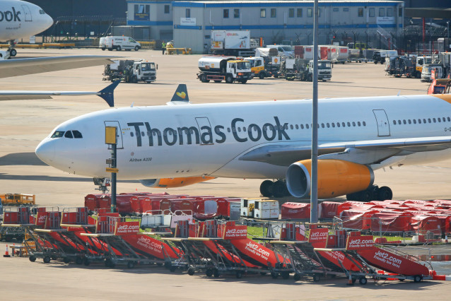 23 September 2019, England, Manchester: An Airbus A330 from the airline Condor with the design of the tourism company Thomas Cook casetas on the tarmac at  Manchester Airport. Thomas Cook, one of Britain's biggest travel firms, filed for liquidation early