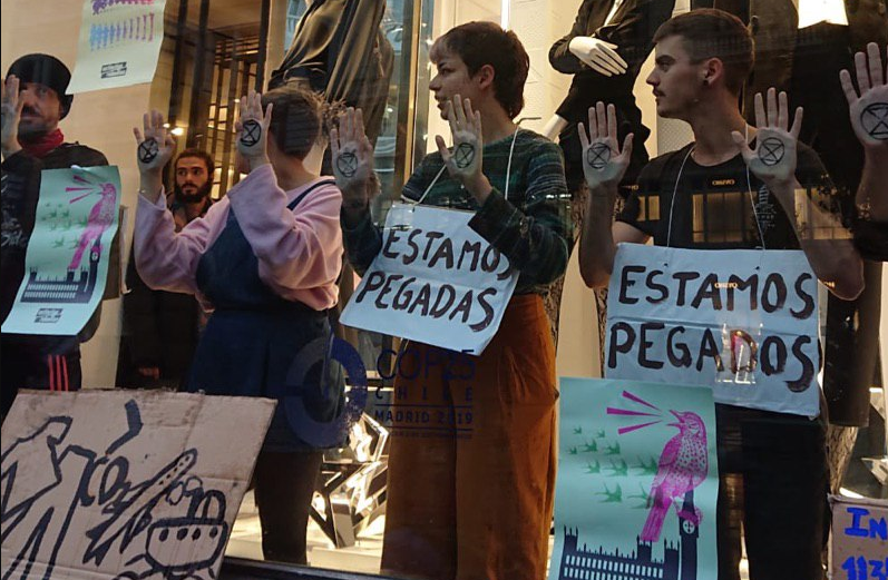 Activistas de Extinction Rebelio no escaparate de Zara en Gran Vu00eda nunha foto da súa Twitter