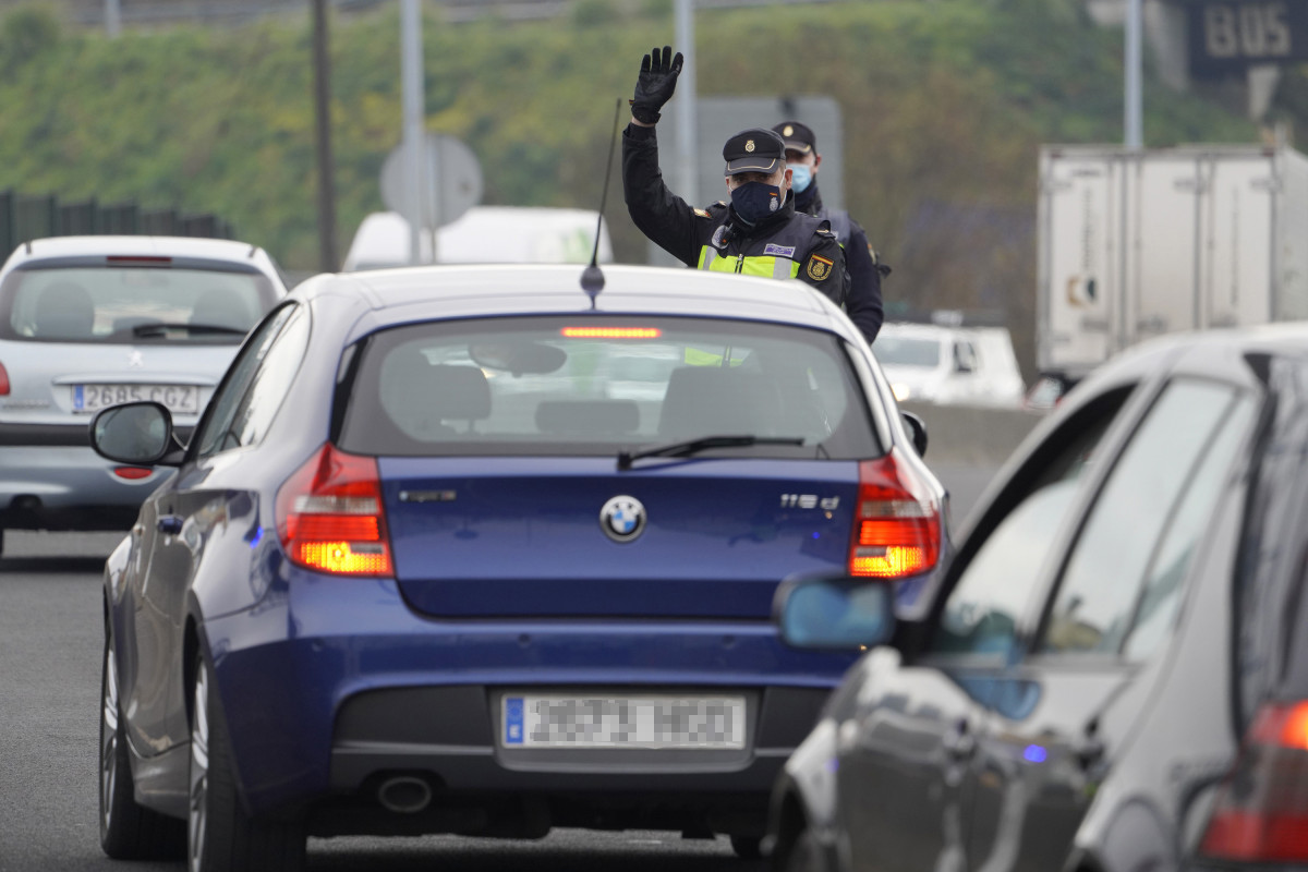 Un axente da Policía Local dá o alto a un coche durante un control de mobilidade na saída de Santiago de Compostela cara á estrada de Ourense, no barrio de Castiñeiriño, en Santiago d